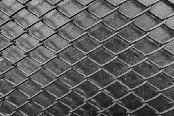 Mesh chain. Black metal mesh on a black background. Loft style. Element of decor. Brutal background.