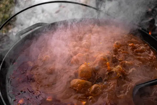Hungarian national dish. Soup with five types of meat. European cuisine. Bograch meat soup. A fatty dish on the fire. Hot street food. Feed the homeless. A dish boiling in a cauldron. Bograch is a Hungarian national meat dish.