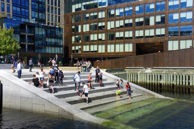 Halifax, Nova Scotia - August 2, 2023: People on the stairs that lead into Halifax Harbour. The stairs located at Queen's Landing were opened in 2021 as part of the Queen`s Marque on the Halifax Waterfront..