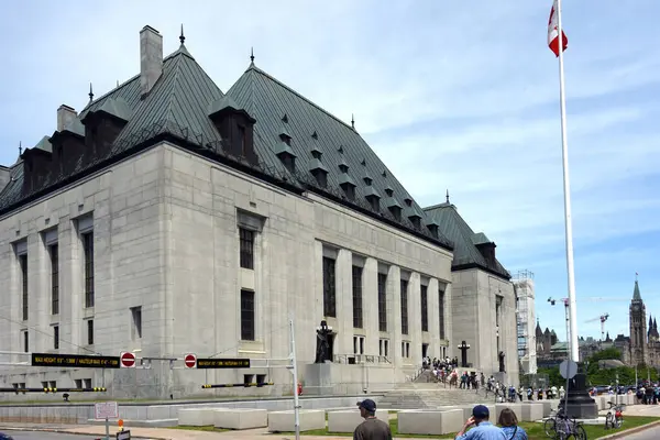 stock image Ottawa, June 1, 2024 A group of people line up to see inside the Supreme Court building as part of the annual Doors Open event which allows people to see inside and learn about various buildings in the area. The Peace Tower can be seen on tje left