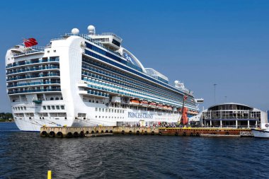 Sydney, Canada - July 29, 2024: Cruise Ship Emerald Princess of Princess Cruises docked at the Port of Sydney in Cape Breton Nova Scotia. Sydney is a popular cruise destination and hosts several cruise ships each year. clipart