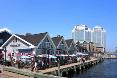 Halifax, Canada - July 30, 2025: People dining on the patio of Pickford and Black, a restaurant on the Halifax Waterfront which is a tourist attraction.