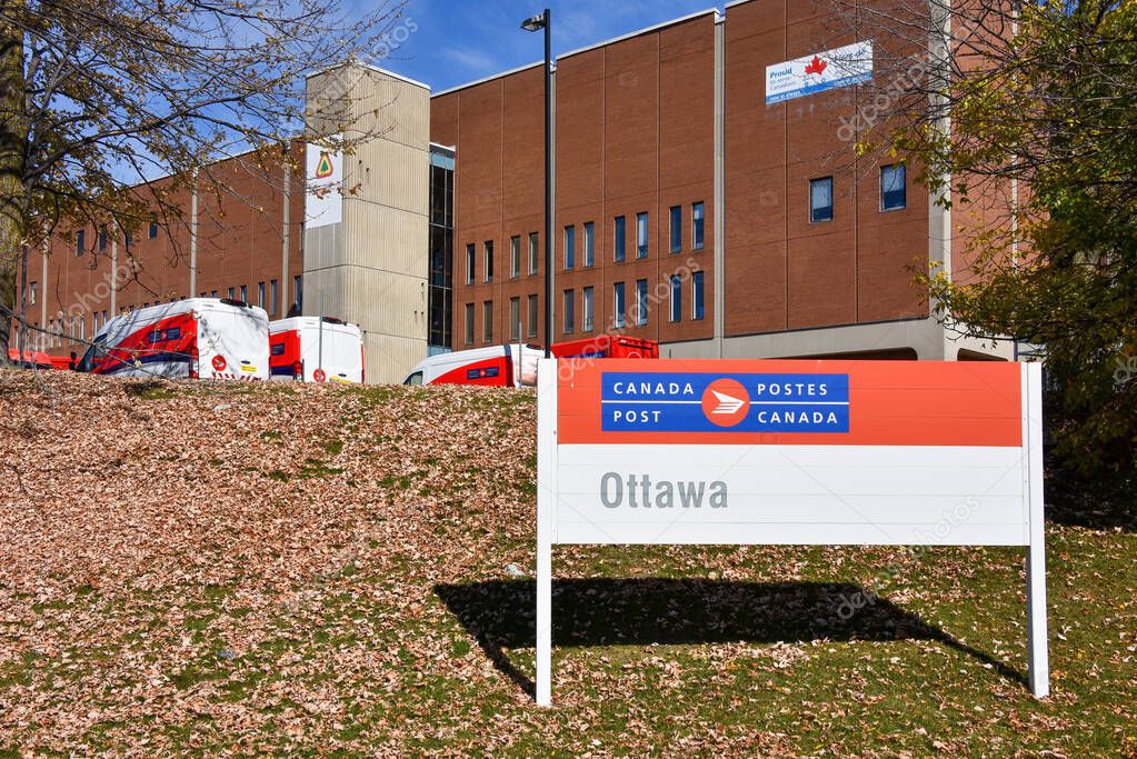October 3, 2025 Sign for Canada Post in Ottawa at Canada Post Place with trucks laying idle due to the strike that started on September 25.