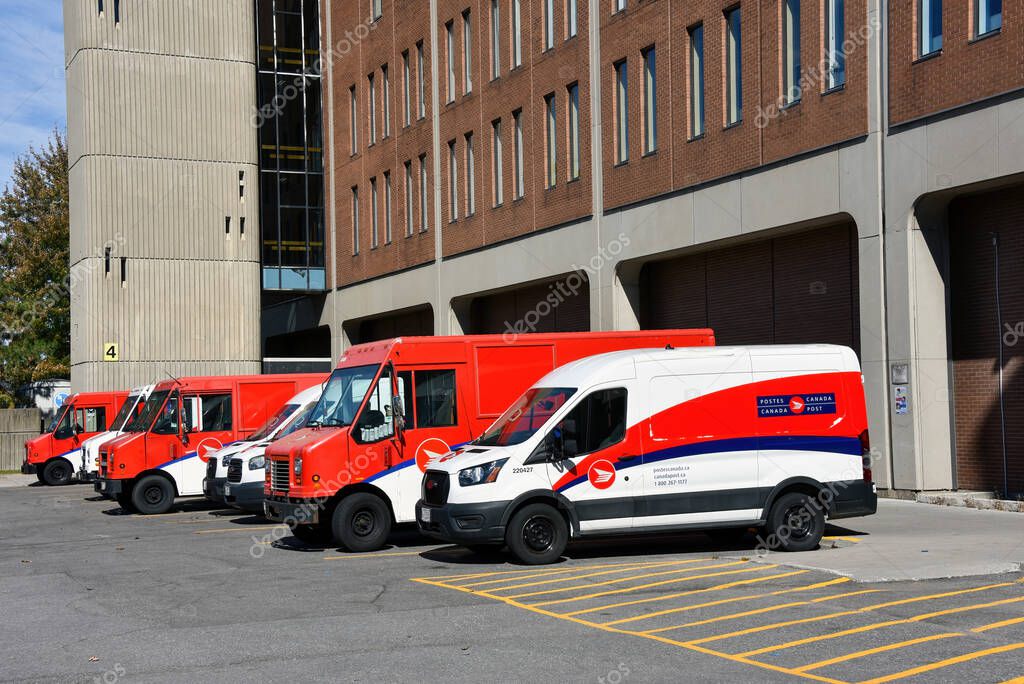 Ottawa, Canada - October 3, 2025: Row of Canada Post trucks and vans parked due to the strike that started on September 25. Most of the trucks will be idle while the strike continues. There a few exceptions such as Social assistance cheques, they wil