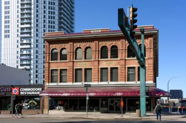 Edmonton Alberta - April 3, 2025: The MacLean Block building constructed in 1909 on Jasper Avenue is the home of Audrey's Books. The Commodore Restaurant is on the left.