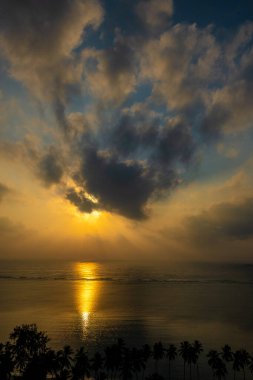 Sabah Kenya 'da güzel bir başlangıç. Sabah güneşi Hint Okyanusu' nun sakin sularına yansıyor. Sahildeki gölgeli palmiye ağaçlarını aydınlatıyor.