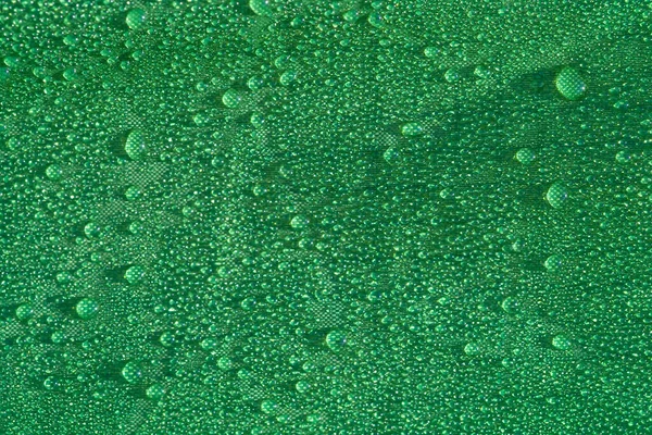 closeup green cloth in water drop after a rain, water drop on cloth background