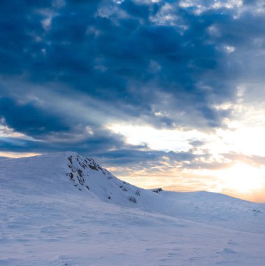 mountain in snow at the sunset