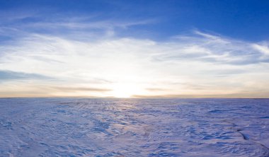wide snowbound  plain at the sunrise, cold winter natural landscape
