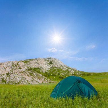 touristic tent stay in mountain plateau at sunny day, mountain touristic camp scene