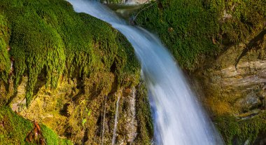 small waterfall rushing over a stones