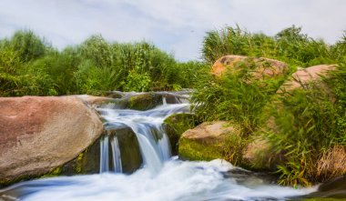 small waterfall rushing over a stones