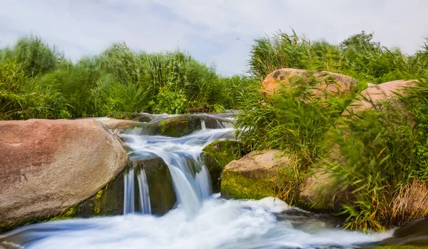 small waterfall rushing over a stones