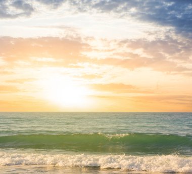 stormy sea coast at the dramatic sunset