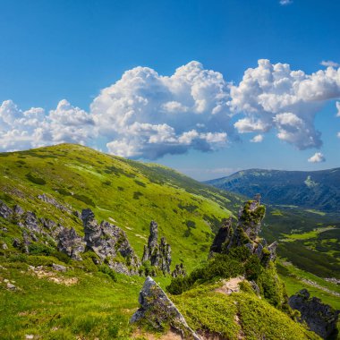 green mountain chain under blue cloudy sky