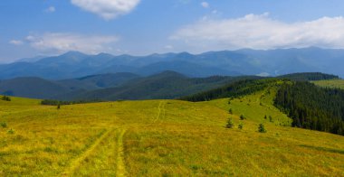 green mountain chain under blue cloudy sky
