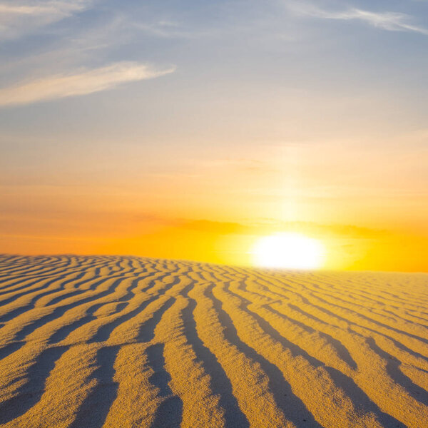 wide sandy desert at the dramatic sunset