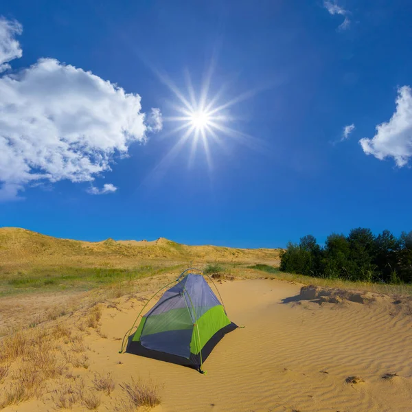 touristic tent among sandy desert at sunny day