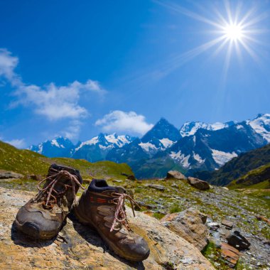 Bir çift turistik bot güneşli bir günde dağda taş üstünde kalır.
