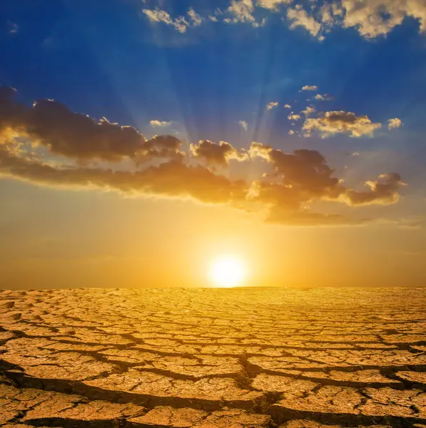Dry Cracked Earth Dramatic Sunset Stock Photo