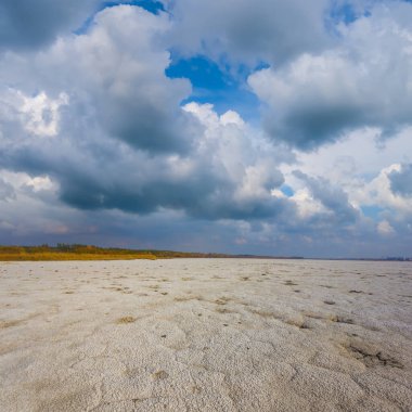Yoğun bulutlu gökyüzünün altında geniş tuzlu arazi