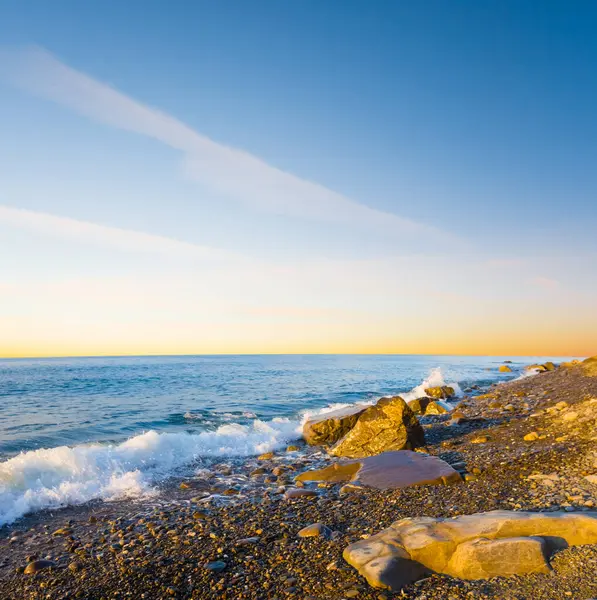 Gün batımında taşlı sahil kıyısı