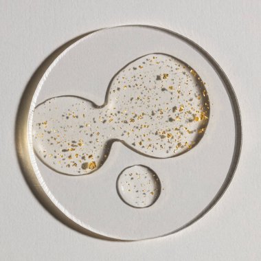 Beyaz zemin üzerinde altın olan bir damla serum, kozmetik dokular, cilt ürünü lekesi yüz serumu, yağ