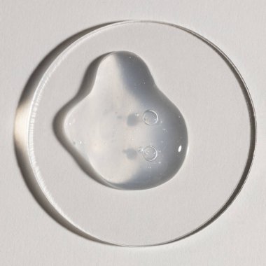 Şeffaf serum, kozmetik dokular, cilt ürünü lekesi yüz serumu, yağ, temizleyici.