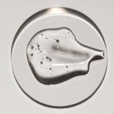 Şeffaf serum, kozmetik dokular, cilt ürünü lekesi yüz serumu, yağ, temizleyici.