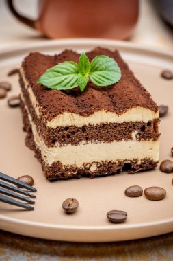 Coffee tiramisu and coffee beans on the plate
