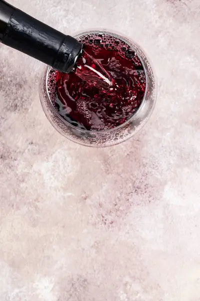 Glass of red wine on the vintage background