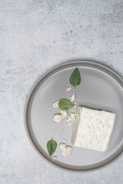 Eski arkaplanda Feta peyniri ve fesleğen yaprakları