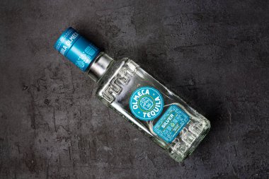 Bottle of tequila on black background. 