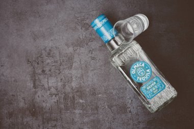 Bottle of tequila on black background. 