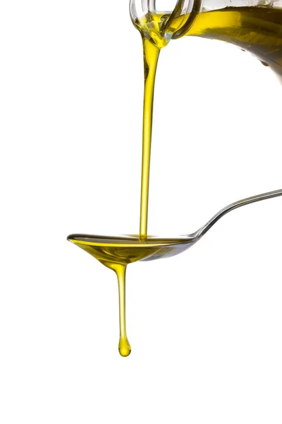 stock image Olive oil flowing to the spoon on the white background