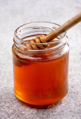 Bir kavanoz bal ve bal kaşığı.