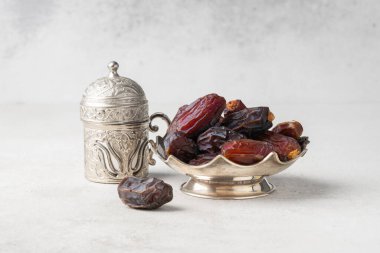 Dried delicious date fruit on vintage stone background clipart