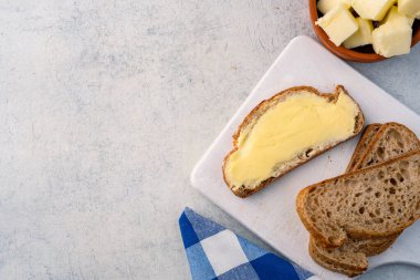 Yemeklere tat katan ve beyaz arka planda kahvaltı için olan tereyağı.