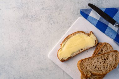 Yemeklere tat katan ve beyaz arka planda kahvaltı için olan tereyağı.