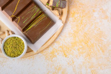 Chocolate bar filled with pistachio kunafa. Dubai chocolate clipart