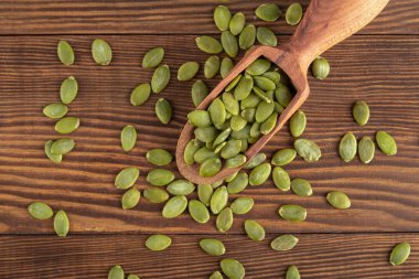 Ahşap arka planda lezzetli kabak tohumları