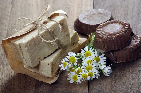 soap, soap and dried brown flower on brown wood. spa