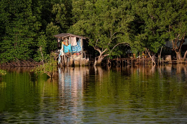 stock image A poor little hut by the waterfront covered with clothes and sheets of cloth tied up with ropes and hung to whichever spaces are available.