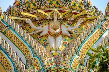 Mystical three head elephant statue at Wat Ratchabophit in Bangkok it is cladded with pieces of various shapes and sizes of colorful ceramic tiles.