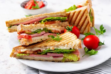 Club sandwich panini with ham, tomato, cheese and lettuce. Top view