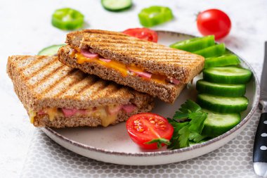 Club sandwich panini with ham and cheese.