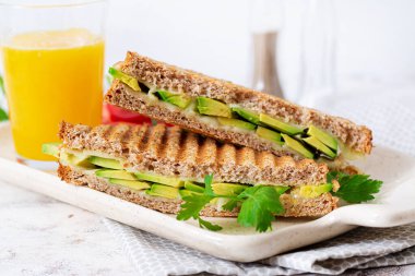 Vegan sandwich with cheese and avocado. Vegetarian breakfast.