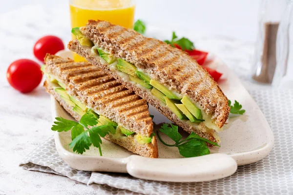Vegan sandwich with cheese and avocado. Vegetarian breakfast.