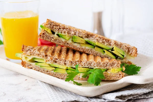 Vegan sandwich with cheese and avocado. Vegetarian breakfast.