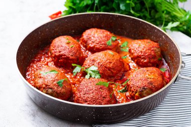 Lazy cabbage rolls stewed in sweet and sour tomato sauce. Meatballs. Beef cutlet.